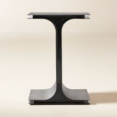 a modern black and silver side table on a white background