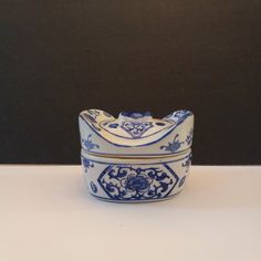 a blue and white bowl sitting on top of a table