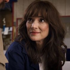 a woman with long hair smiling at the camera