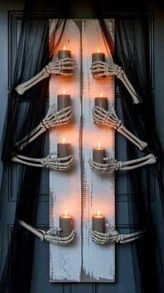 a group of candles are arranged in the shape of a christmas tree with skeleton arms and legs