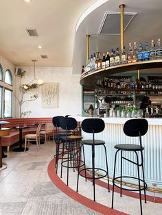 the inside of a restaurant with several bar stools