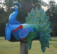 a blue mailbox with a peacock painted on it