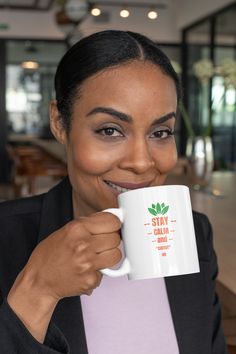 a woman holding a black coffee mug in her right hand and the words i'm probably not driving printed on it