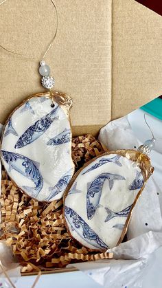 two blue and white plates in a cardboard box