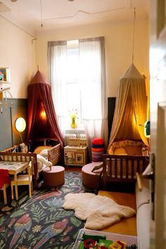 a child's bedroom with two beds and toys on the floor in front of a window