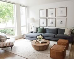 a living room filled with furniture and lots of pictures on the wall above it's windows