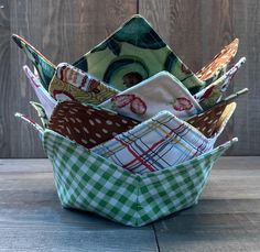 an origami basket filled with folded fabric