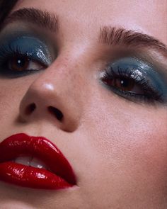 a woman with blue eyes and red lipstick