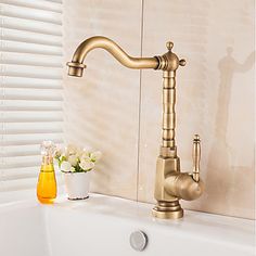 a faucet that is sitting on the side of a sink in a bathroom