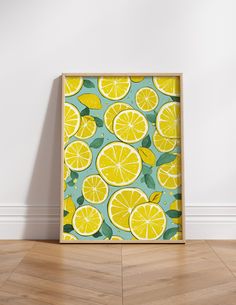 a yellow and green lemon print on a white wall in an empty room with wood flooring