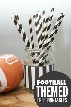 football themed paper straws in a mason jar with black and white striped straws