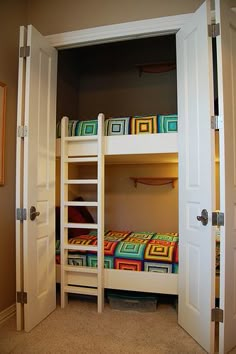 there is a bunk bed in the room with two doors open to let in some light