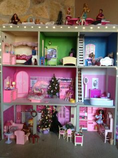 a large doll house with all the furniture and accessories in it's display case