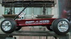 the radio flyer wagon is on top of a table in front of some other items