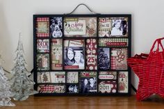 a christmas tree and other decorations on a shelf in front of a wall with pictures