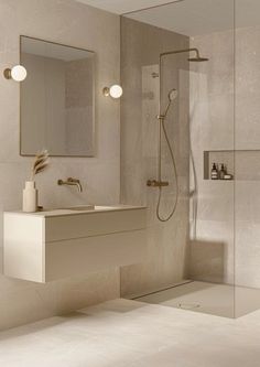 a bathroom with a shower, sink and mirror