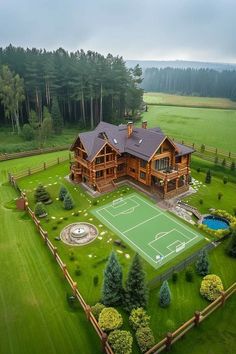 an aerial view of a large house with a tennis court in the middle of it