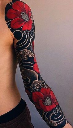 a man's arm with red flowers on it