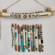 a group of wooden sticks sitting next to each other on a white surface with blue and black designs