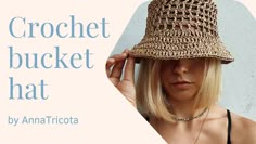 a woman wearing a straw hat with the words crochet bucket hat