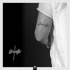 a black and white photo of a woman's arm with the word strength tattooed on it