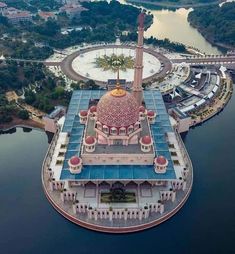 an aerial view of a building in the middle of water