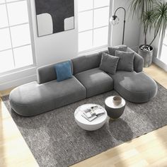 a modern living room with grey couches and pillows