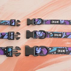 four black and purple straps with an em & me design on the bottom one is for snowboarders