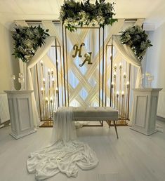 a room decorated with white flowers and greenery