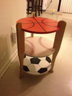 a table with a basketball and soccer ball on it in the middle of a room