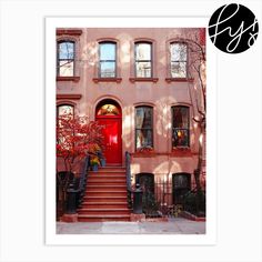 a red door is on the side of a pink building with steps leading up to it