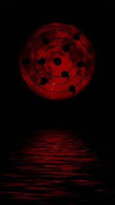 a red object floating on top of water in the middle of a dark night sky