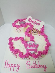 a birthday cake is decorated with pink icing