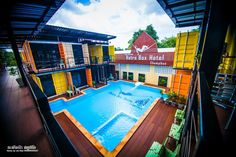 an outdoor swimming pool surrounded by colorful buildings