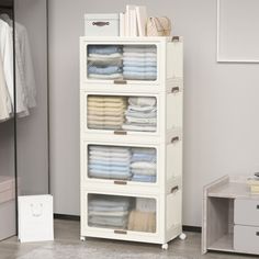 an organized closet with folded towels and other items in it, along with a white dresser