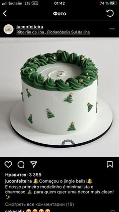 a white cake with green icing and christmas trees on it