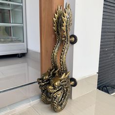 a golden dragon head on the side of a wall in front of a store window