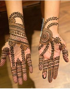 two hands with henna designs on them