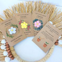 four flower seed packets sitting on top of a straw wreath next to eggs and flowers