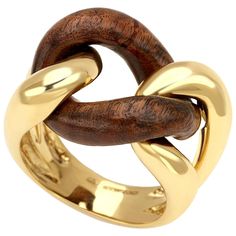 Description: This exquisite groumette ring combines the luxurious appeal of 18 karat yellow gold with the durability and rich texture of rose wood. Known as one of the most resistant and precious woods, rose wood adds a unique and elegant touch to this piece. Part of the iconic Micheletto collection, this ring was originally crafted solely in gold. Over the past decade, the inclusion of wood has become increasingly popular, adding a contemporary twist to the classic design. Material: 18 Karat Ye Luxury Gold Plated Jewelry With Ring Detail, Luxury Recycled Gold Ring Jewelry, Luxury Gold Plated Fine Jewelry Rings, Luxury Gold Plated Jewelry With A Modern Twist, Classic Luxury Gold-plated Rings, Luxury Adjustable Rings With Intricate Design, Luxury Carved Rings As A Gift, Luxury Modernist Rings For Everyday Wear, Luxury Yellow Gold Jewelry With Ring Detail