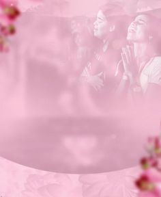 two people standing in front of pink flowers with their hands together and looking up at the sky