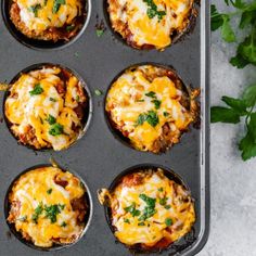 an overhead view of some tasty looking food in a muffin tin with parsley on top