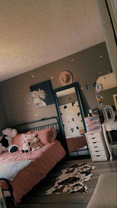 a bed room with a neatly made bed next to a dresser and mirror on the wall