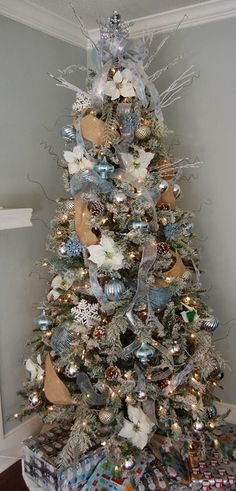 a decorated christmas tree with silver and gold ornaments