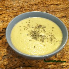 a blue bowl filled with soup on top of a counter