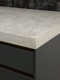 a close up of a counter top with black drawers