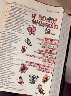 an open bible with butterflies on it and the words, a godly woman is