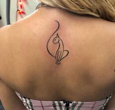 a woman with a cat tattoo on her back