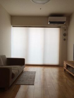 a living room with hard wood floors and sliding glass doors