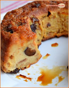 a close up of a piece of cake on a plate with some oil spilled around it